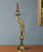 Decorative candle holder with parrot design on a white background