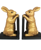Gold rabbit bookends on a white background