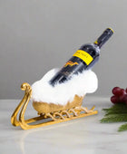 Wine bottle on a decorative gold stand with a white background