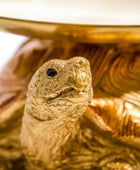Gold turtle figurine on a decorative base