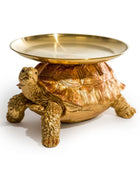 Gold turtle-shaped dish on a white background