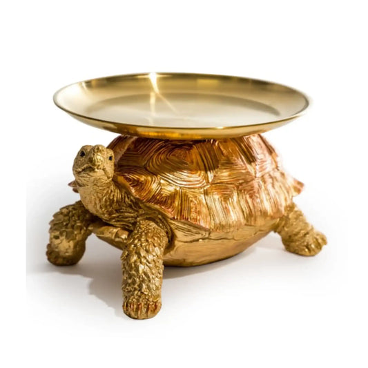 Gold turtle-shaped dish on a white background