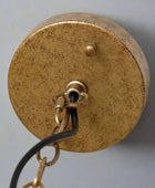 Brass light fixture on a white background
