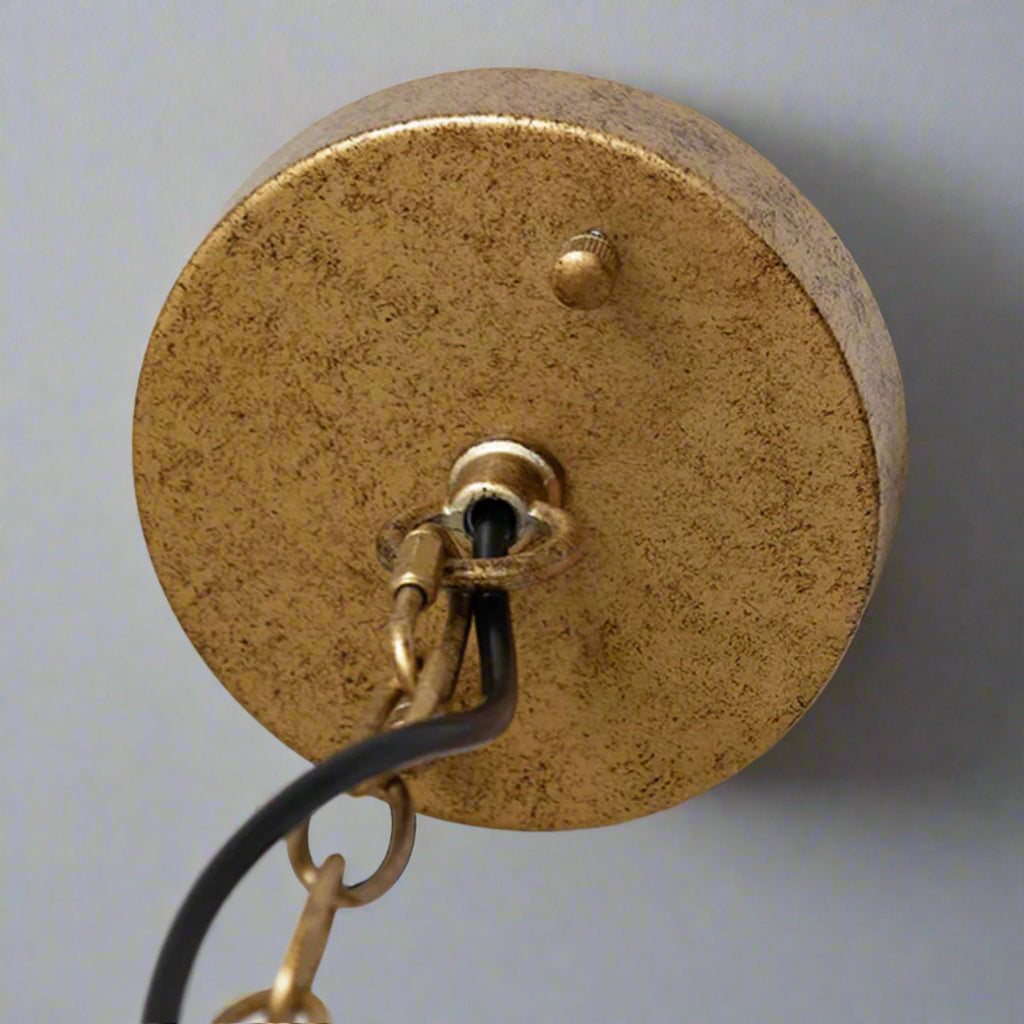 Brass light fixture on a white background