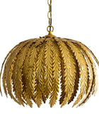 Gold leaf-patterned pendant light on a white background