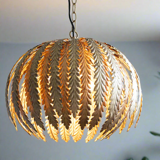 Decorative pendant light with leaf-like design on a blurred background