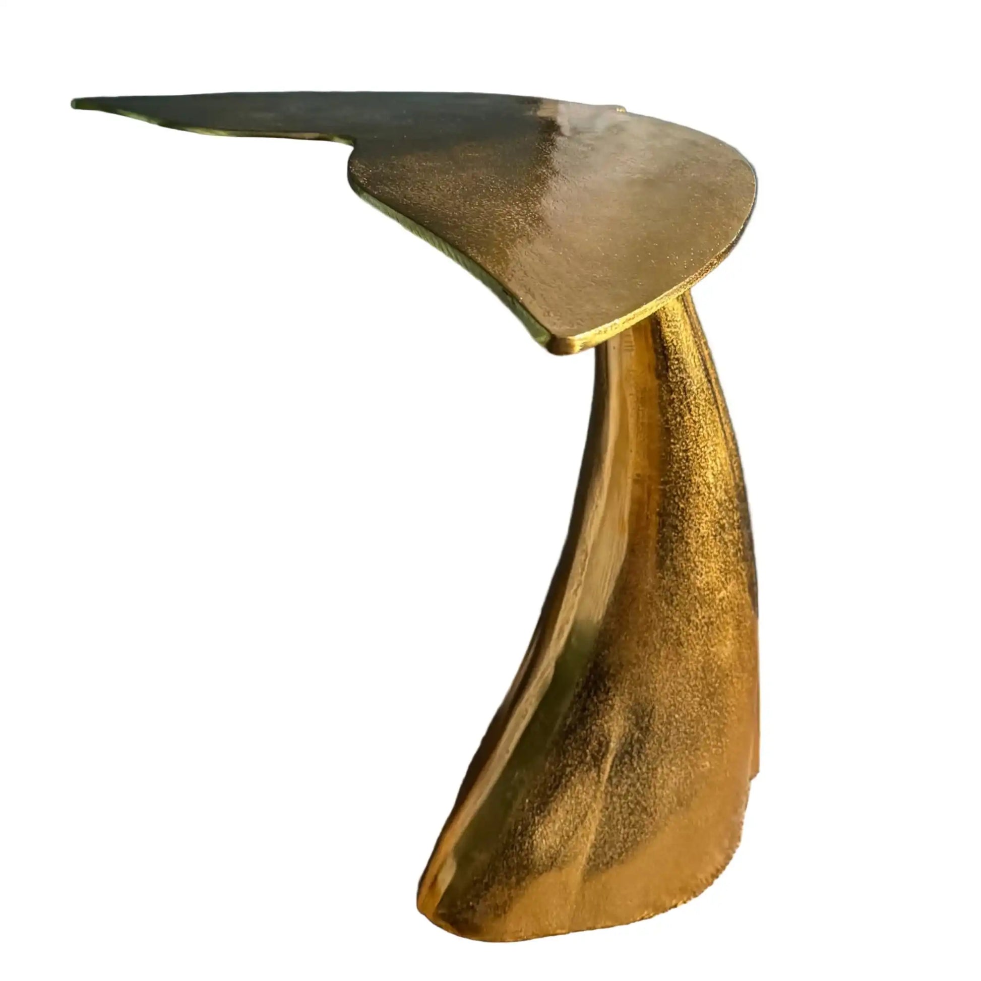 Gold side table on a wooden floor with a plant and basket in the background