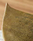 Close-up of a textured brown ceramic plate with a blurred background