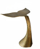 Bronze-colored tail-shaped object on a white background