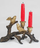 Decorative candle holder with birds and red candles on a white background
