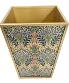Decorative trash bin with floral pattern on a white background