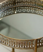Decorative round mirror with intricate gold frame on a white background