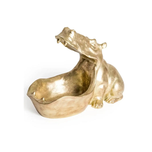 Gold-colored sculpture of a stylized animal on a white background