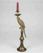 Decorative candle holder with parrot design on a white background