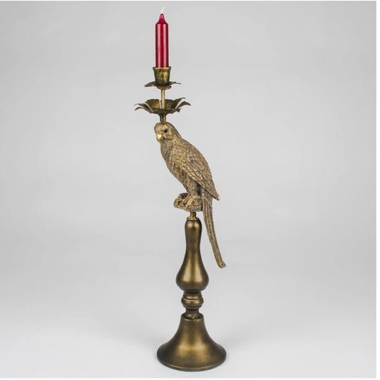 Decorative candle holder with parrot design on a white background