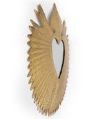 Decorative wall mirror with gold wing-like design on a white background