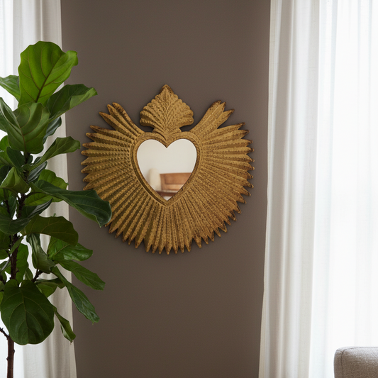 Decorative wall mirror with heart design on a brown wall, next to a plant and window.