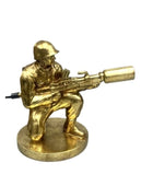 Gold-colored figurine of a soldier with a weapon on a white background