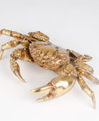 Gold crab figurine on a white background