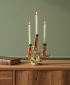 Candle holder with coral design holding four candles on a white background