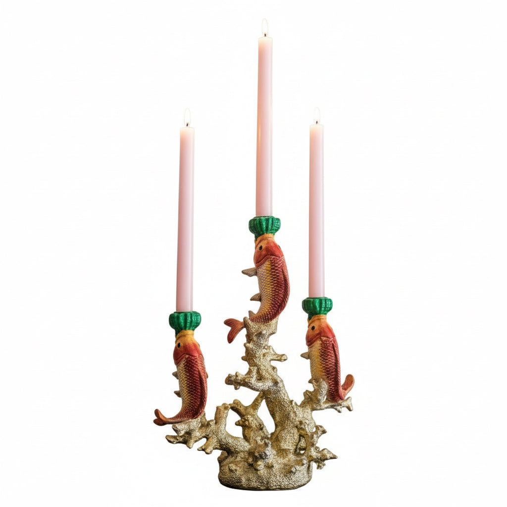 Candle holder with fish design holding three candles on a white background