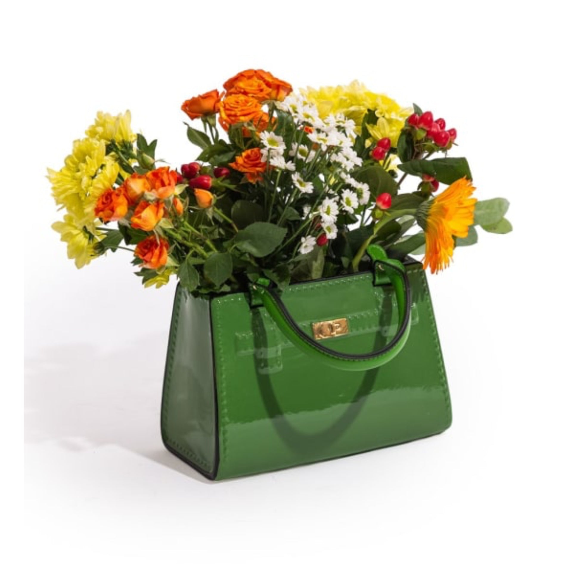 Green handbag filled with colorful flowers on a white background
