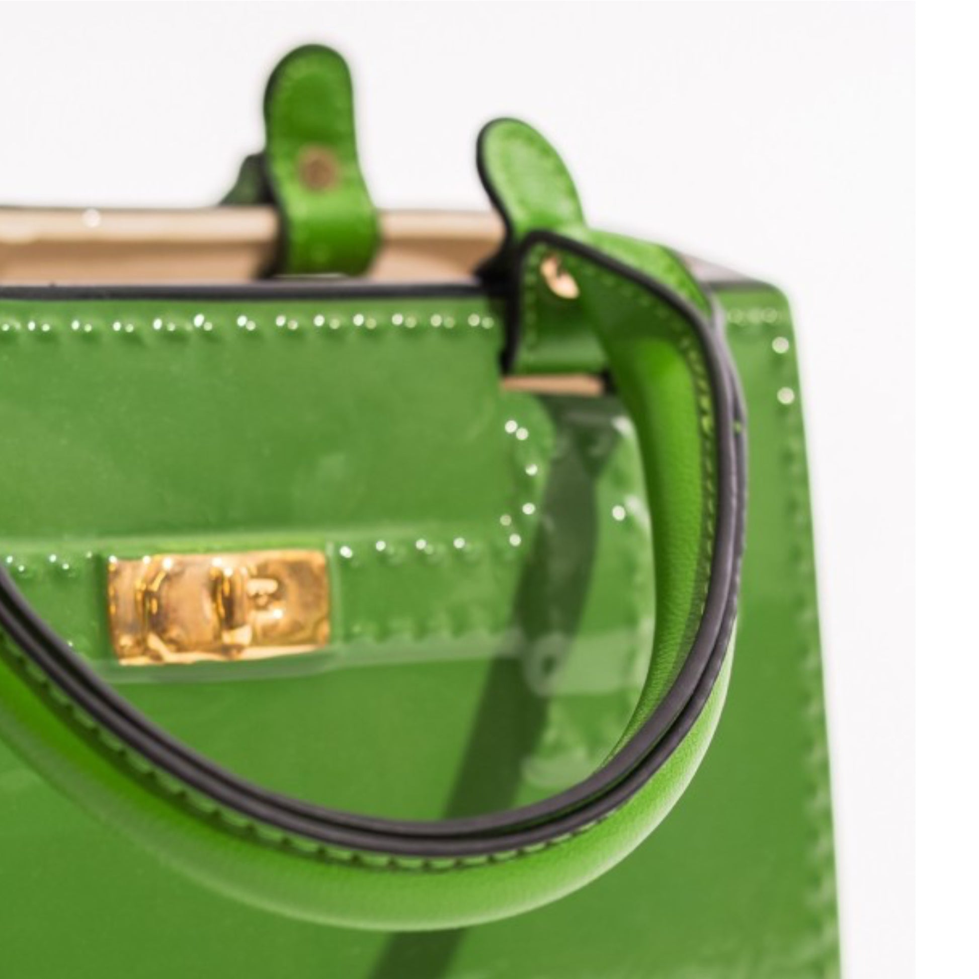 Green handbag with gold clasp on a white background