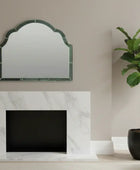 Living room with marble fireplace, mirror, and potted plant