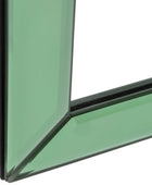 Close-up of a corner where green glass meets black frame on a white background