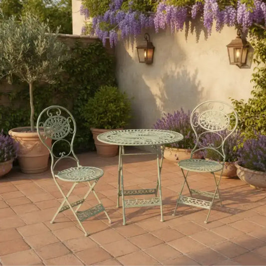 Outdoor patio set with two chairs and a table on a brick patio.