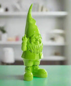Green garden gnome figurine on a white background