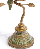 Decorative lamp with gold and green details on a white background