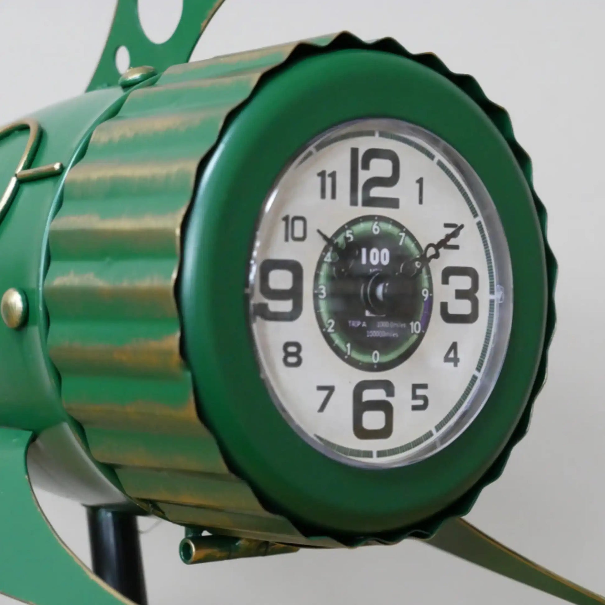 Green clock with a white face on a plain background
