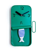 Green wall clock with a fish design on a white background