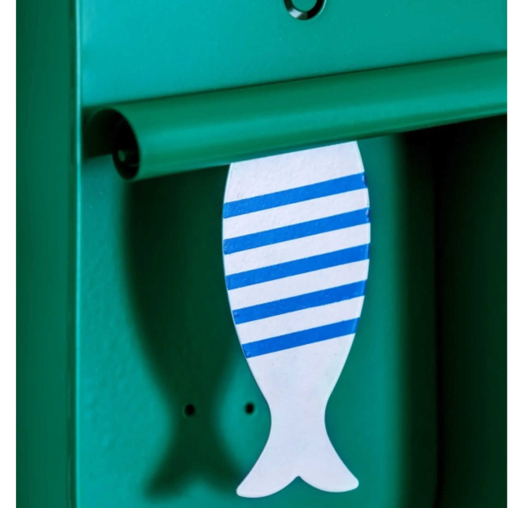 Green mailbox with a fish-shaped mail slot cover featuring blue and white stripes.