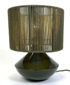 Table lamp with a green woven shade and black base on a white background