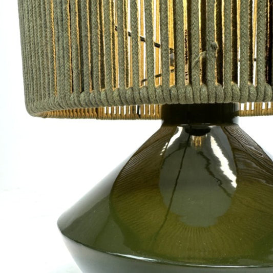 Close-up of a green lamp with a textured shade on a white background
