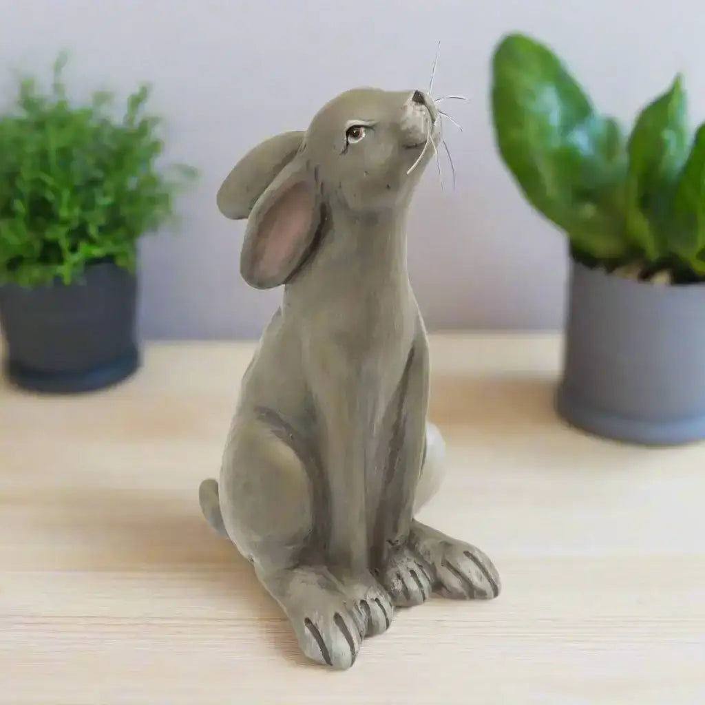 Gray ceramic rabbit figurine on a white background