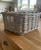 Woven basket on a dark surface with a blurred indoor background