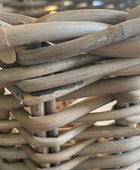 Close-up of a woven basket with natural wooden planks.