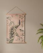 Decorative wall hanging with peacock design on a beige wall.