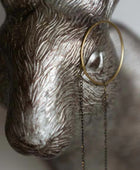 Decorative wall hook shaped like a deer head with a magnifying glass on a neutral background