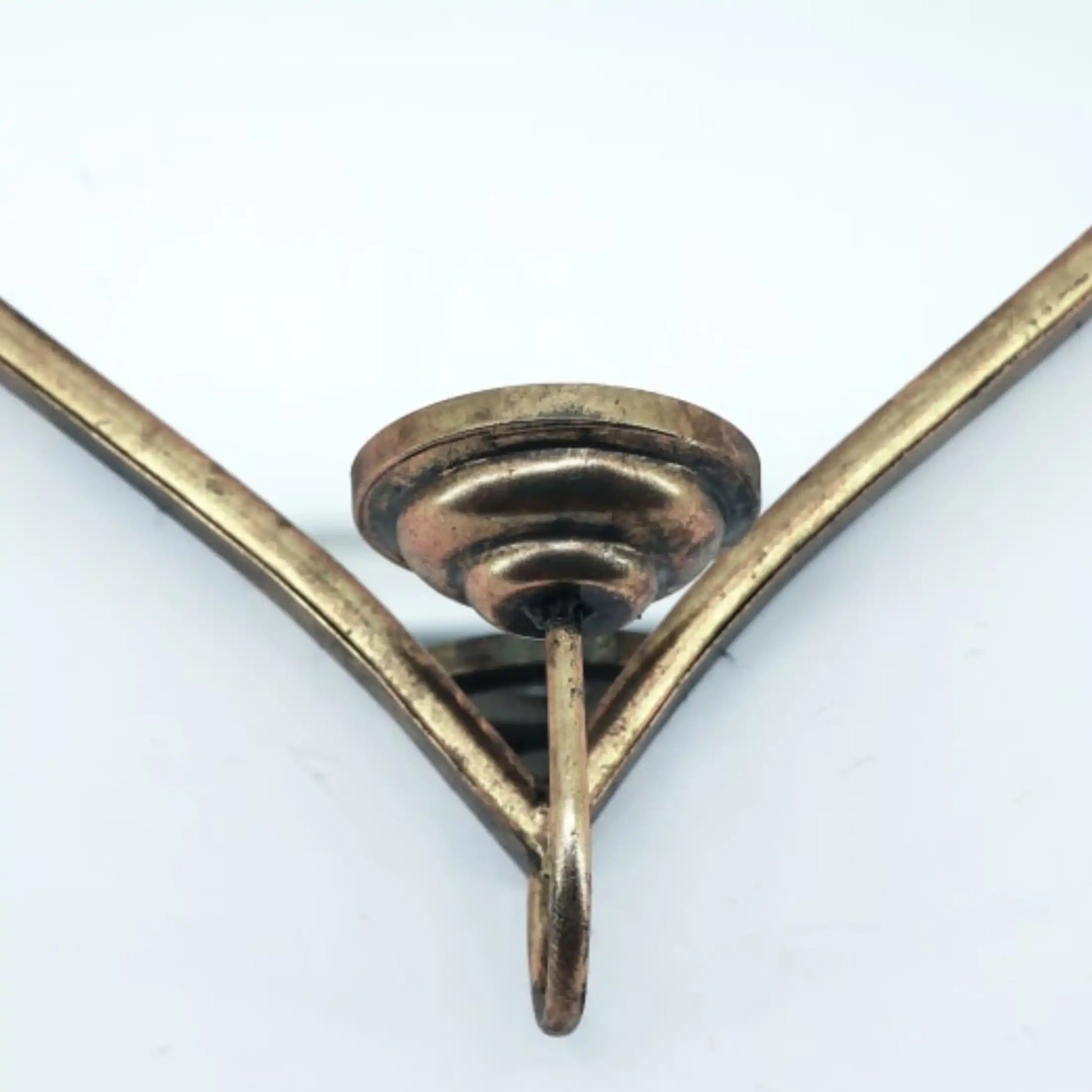 Close-up of a brass bracket on a white background