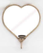 Heart-shaped mirror with a candle holder on a white background