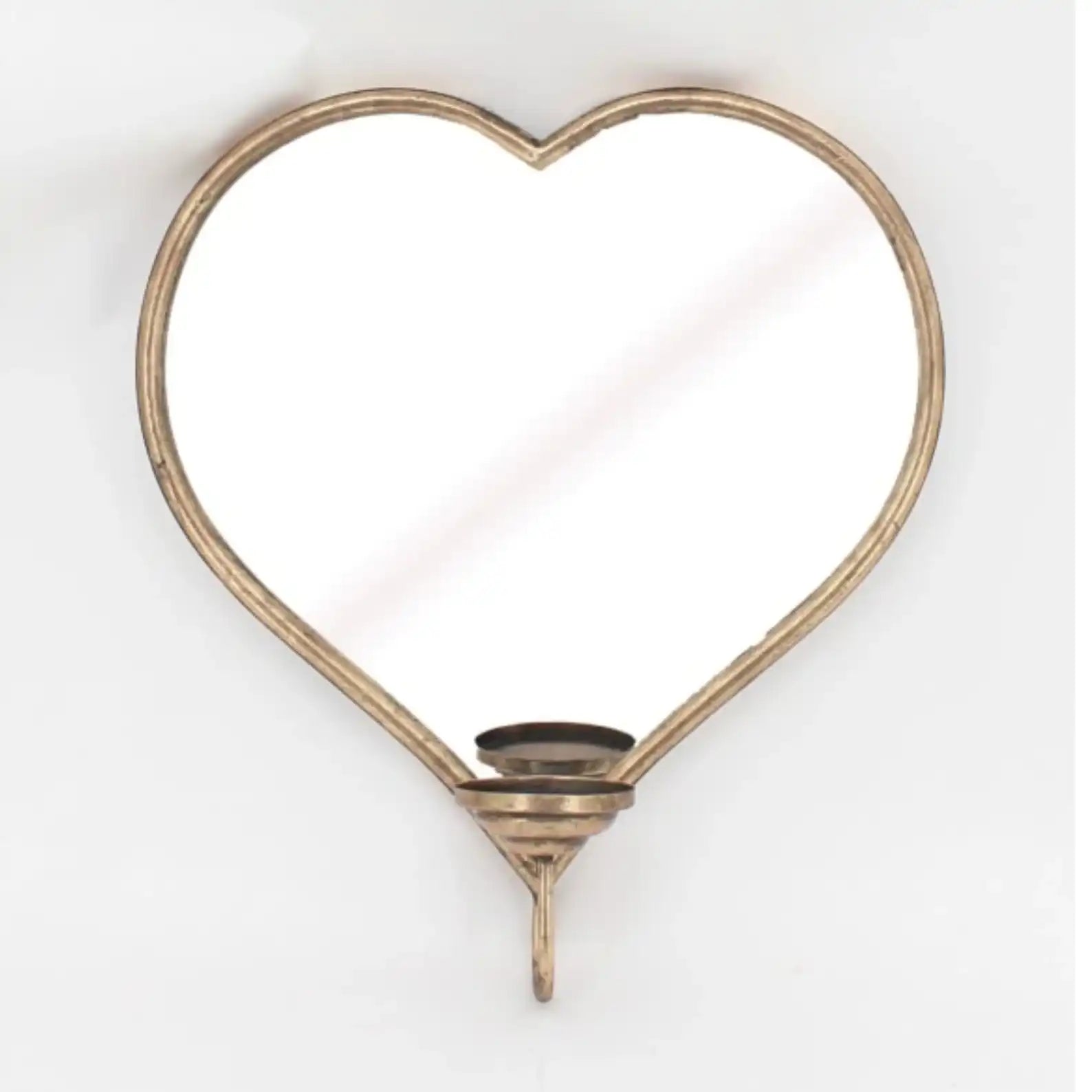 Heart-shaped mirror with a candle holder on a white background