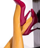 Close-up of red and yellow high-heeled shoes on a white background