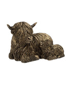 Bronze sculpture of a mother cow and calf on a white background