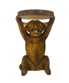 Brown bear figurine lifting a log on a white background