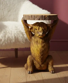 Wooden animal-shaped side table with a fluffy white chair in the background