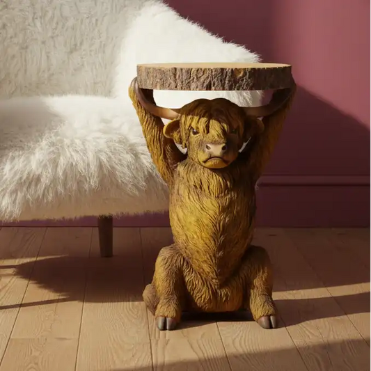 Wooden animal-shaped side table with a fluffy white chair in the background
